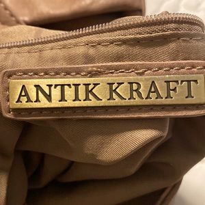 Pinkish faux suede trim fold over shoulder bag with tassel trim